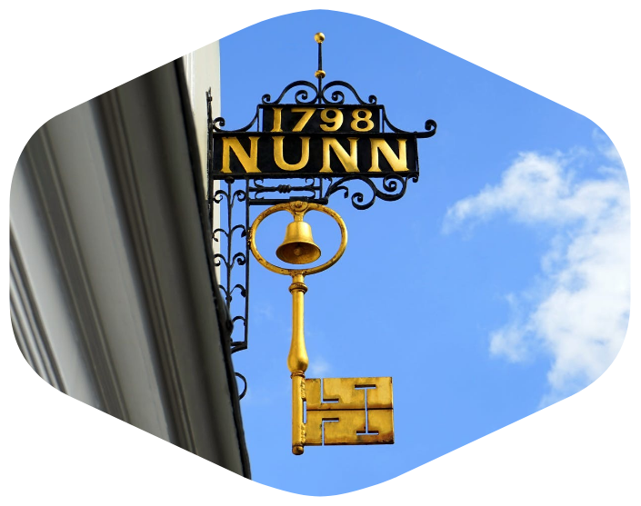 Outdoor Metal Hanging Signs of Nunn installed in Philadelphia, PA